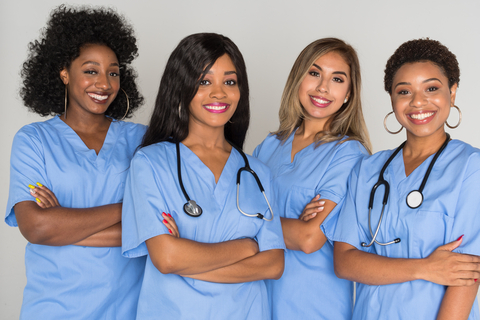 A group of diverse nursing students smiling on campus in Michigan, representing top accredited nursing programs in 2025