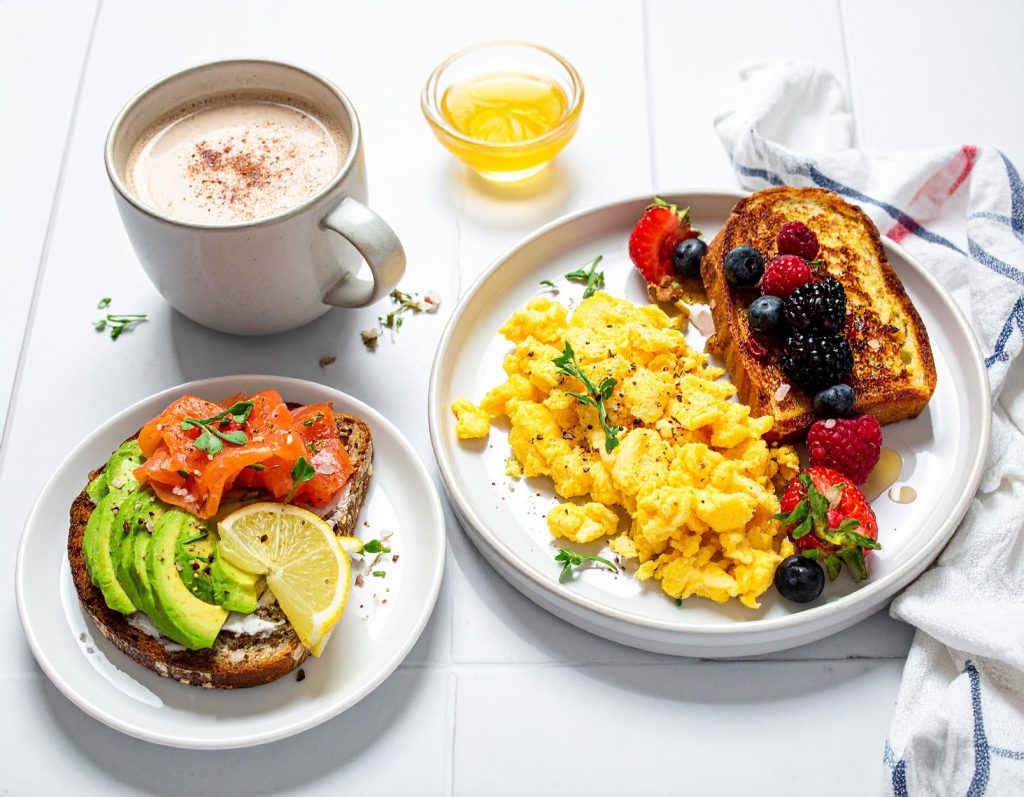 A festive Christmas morning breakfast table with French toast, scrambled eggs, fresh fruit, smoked salmon toast, and warm drinks.