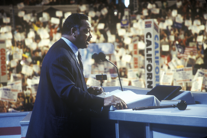 Rev. Jesse Jackson speaking at a public event, remembered for his leadership in the civil rights movement and his decades of advocacy for racial justice in the United States.