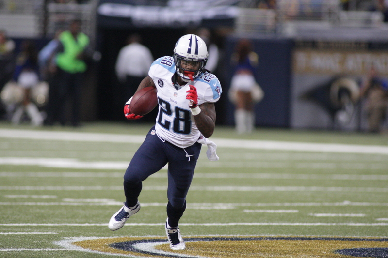 Former Tennessee Titans running back Chris Johnson sprinting down the football field during an NFL game while wearing his Titans uniform.