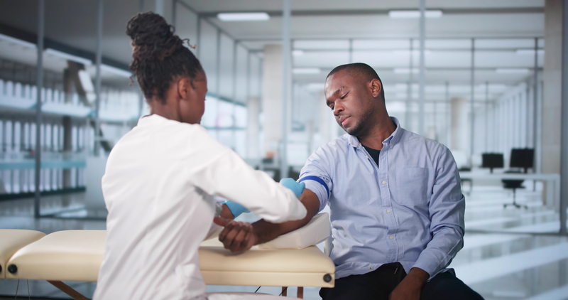 Healthcare professional collecting a blood sample from a diverse patient as part of multicancer early detection screening.