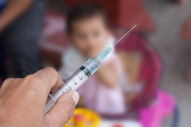 Parent learning about new childhood vaccine changes